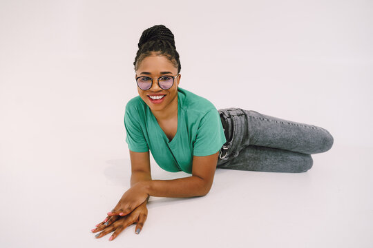 portrait of a person laying on the floor and smiling