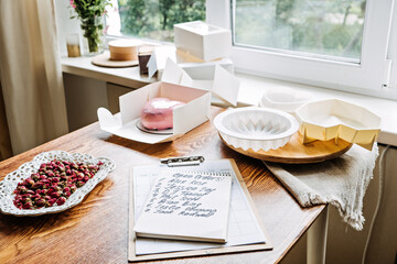 Bakery small local business. Specialty cakes for weddings, birthdays and anniversaries. Female Confectioner baker make cake in kitchen Bakery.