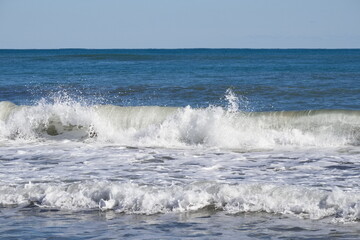 Striking scene of waves breaking on the sand of a Spanish beach	

