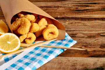 Typical Italian dish mixed deep fried seafood: shrimp, squid, octopus. Unhealthy food, fast food, street food.