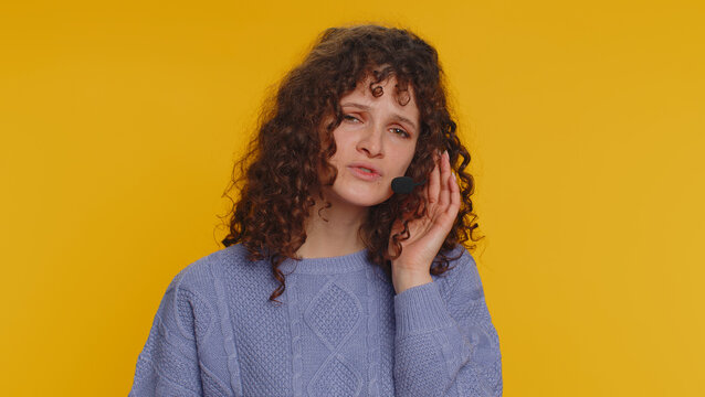 Smiling Curly Haired Woman Wearing Headset, Freelance Worker, Call Center Or Support Service Operator Helpline, Having Talk With Client Or Colleague, Communication Support. Girl On Yellow Background