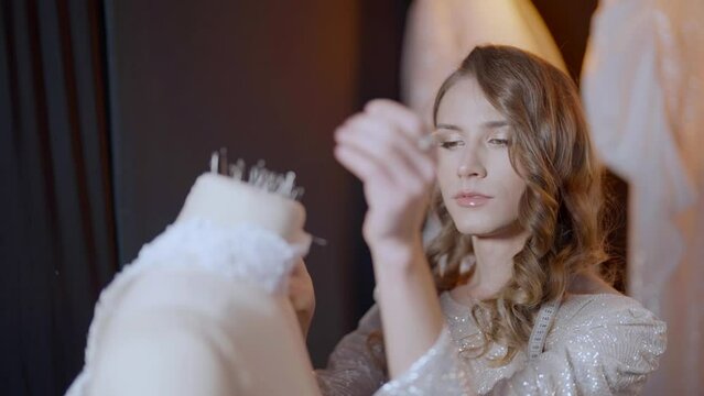 effeminate gay man is trendy fashion designer, working alone in his studio, lgbt community