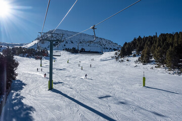 Fototapeta na wymiar Panoramic view of a ski slope in the Pyrenees in Andorra, on sunny day and blue sky.