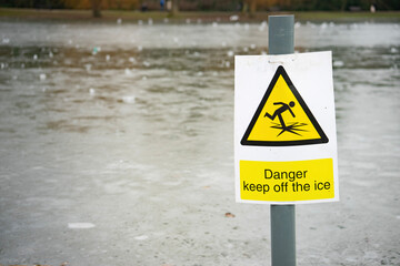 danger ice warning by frozen lake
