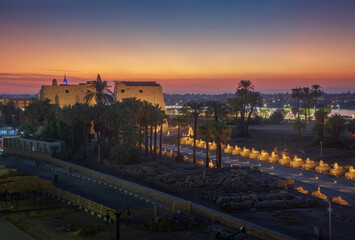Luxor temple in honor of the god Amun-Ra and the alley of sphinxes after sunset