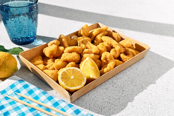 Typical Italian dish mixed deep fried seafood: shrimp, squid, octopus. Unhealthy food, fast food, street food.