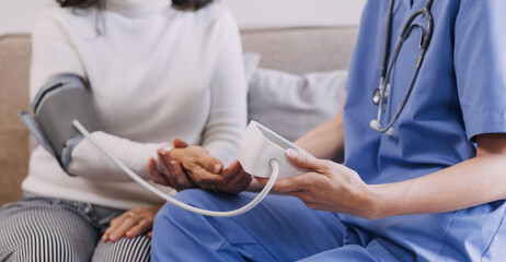 Obraz premium Homecare nursing service and elderly people cardiology healthcare. Close up of young hispanic female doctor nurse check mature caucasian man patient heartbeat using stethoscope during visit