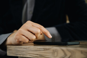 Mature businessman using a digital tablet to discuss information with a younger colleague in a modern business lounge