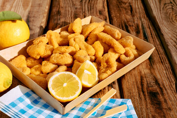 Typical Italian dish mixed deep fried seafood: shrimp, squid, octopus. Unhealthy food, fast food, street food.