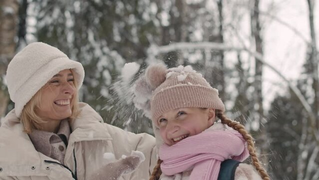 Slowmo Of Happy Mom With 12 Year Old Daughter Spending Time Together In Snowy Winter Forest On Weekend