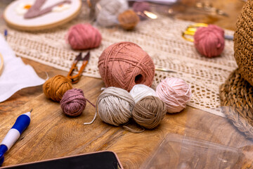Fototapeta na wymiar Different colored balls of wool for punch needle embroidery.