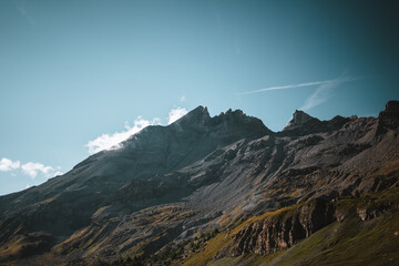 Majestic mountains in the Alps covered with trees and clouds