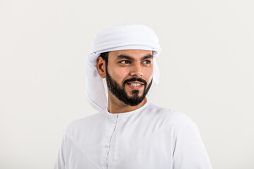 Handsome man with traditional white kandura from uae. Studio portraits with Dubai outfit about fashion and lifestyle