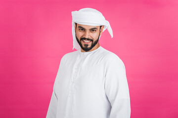 Handsome man with traditional white kandura from uae. Studio portraits on colored backgrounds with Dubai outfit, about fashion and lifestyle