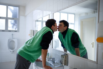 Fototapeta premium young boy exploring different emotions in front of the mirror