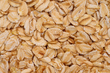 Macro photo of oatmeal. Texture, background of dry oatmeal.Healthy, delicious food, source of amino acids,minerals.