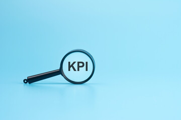 look at the text KPI through a magnifying glass on a blue background