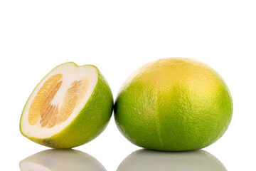One whole and one half juicy organic Citrus Sweetie, close-up, isolated on white.