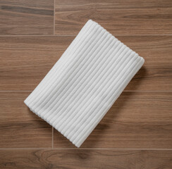 White terry towel close-up folded on a wooden table