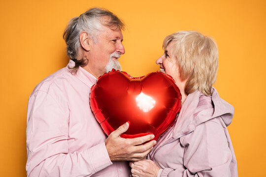 Senior couple with heart balloon