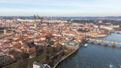 Naklejka na ściany i meble Aerial view of River and buildings in Old Town of Prague, Czech Republic. Drone photo high angle view of City