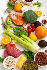 Food background vegetables green uncooked fish meat on light surface
