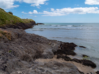 View of the Cape of the Virgin Mary on a sunny day. The rocky Irish coast, rock formation near body of water.