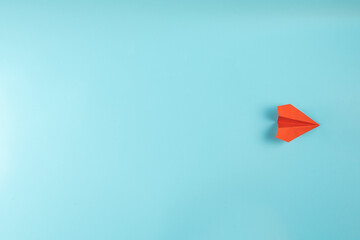 Paper airplane red on blue background Concept of travel, the route of the paper airplane.
