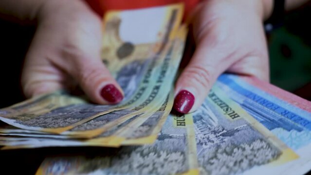 Woman's hands count Hungarian forint, Hungarian banknotes