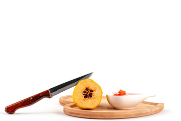 Close up knife Fresh bowl ripe quince and jam on white background isolated seed.	
