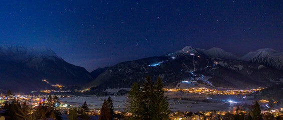 night sky above the city of ehrwald
