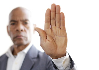 black man holding hand up saying stop on white background stock photo