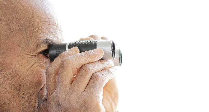 looking through binoculars with white background stock photo