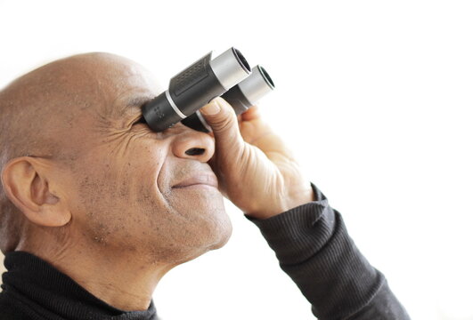 looking through binoculars with white background stock photo