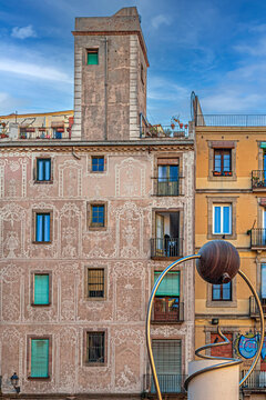 Historic buildings in Pla&ccedil;a George Orwell and sculpture EL TRIPI, Barcelona, Spain