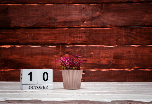 October calendar with number  10. Planner copy space on a wooden brown background. March number icon. Place for text background calendar
