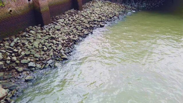 Very Light Waves Splasing On A Bed Of Rocks