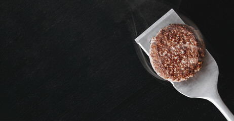 barbecue burger cutlet. barbeque concept in nature. barbecue spatula with a burger patty on it