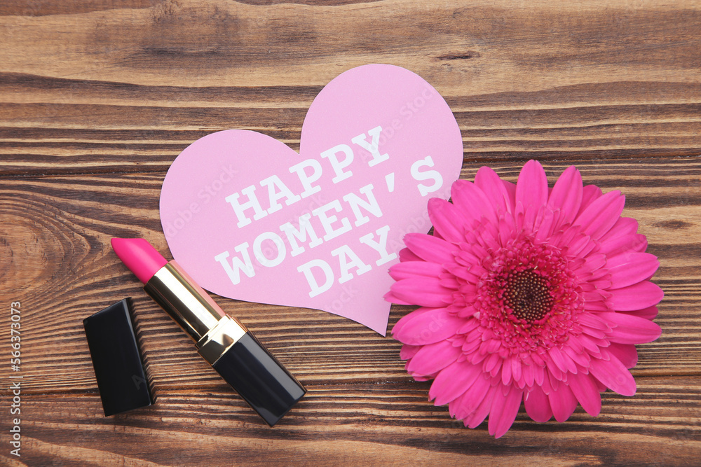 Canvas Prints Gerbera flower, lipstick and card in shape of heart with text Happy Women's Day on brown wooden background