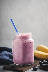 Blueberry and banana smoothie drink in a glass jar, healthy eating concept