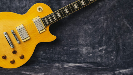 Yellow Les Paul electric guitar on a fur background
