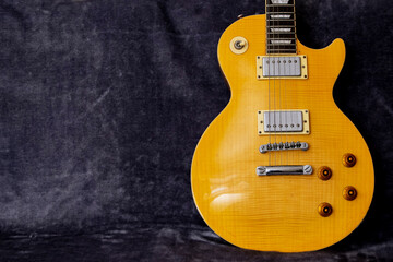 Yellow Les Paul electric guitar on a fur background
