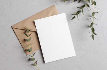 Invitation or greeting card mockup with envelope and eucalyptus twigs