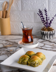 Close Up Turkish Deserts Baklava Stuffed With Mussels On A Kitchen Concept Plate. (Turkish Name: Midye Dolma Baklava)