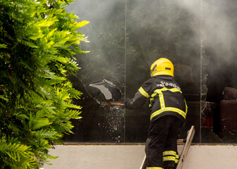 National Fire Fighter of Sri Lanka trying to fight a fire going on in a commercial store in...