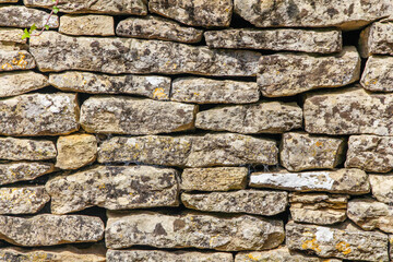An old cobbled wall, stone masonry. Abstract natural backgrounds and textures