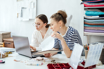 Successful Business Partners, small business partnership. Two Female jewelry artists designer, business owners making jewelry in their studio.