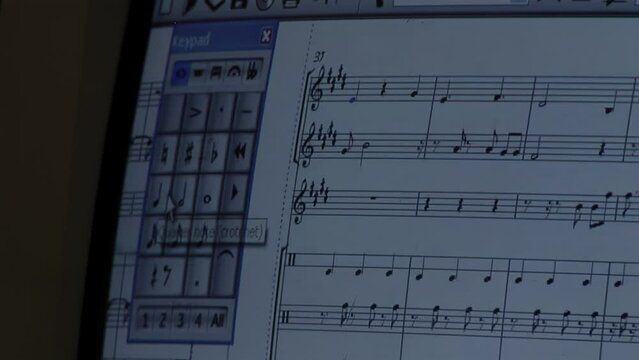 Musician Using a Music Note Writing and Composing Software at his Home. Close Up.