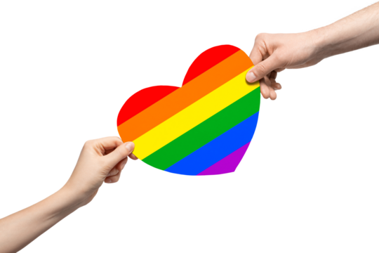 Rainbow colored cardboard heart in two hands.