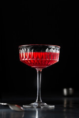 Kir royal cocktail on black moody background